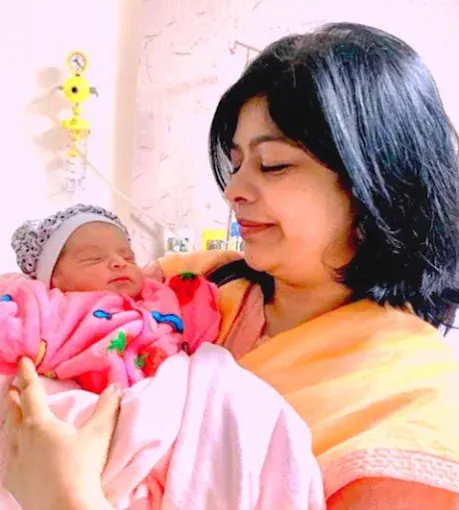 Dr. Bhavya Rathore holding a newborn