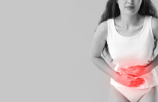 Woman holding her lower abdomen in pain